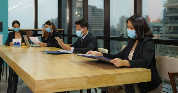 new normal business practise of business people working in business office wearface shield to protection of coronavirus covid-19 infection. business new normal to protect coronavirus to work in office