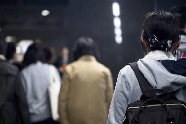 People walking in Kyoto, Japan train station.