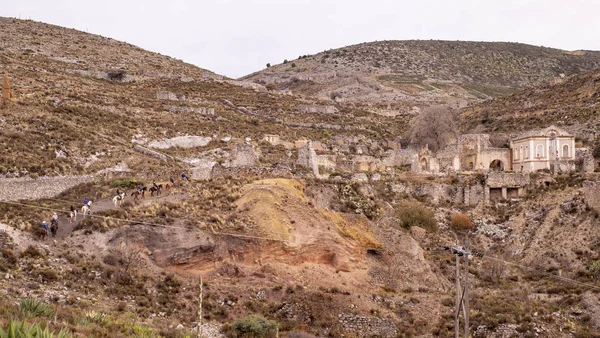 Mexican town of Real de Catorce with ruins and tourist group