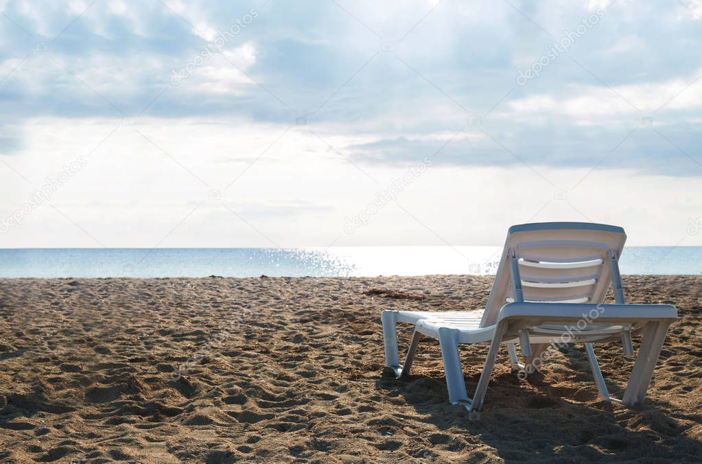 chaise lounges on the beach of the sea