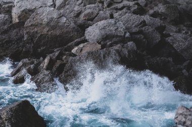 Deniz dalgaları taşları dövüyor