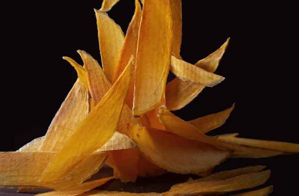 mango dried slices on black background