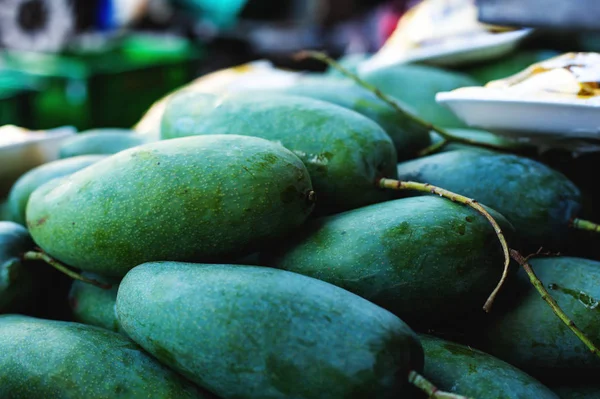 green mangoes on the street market