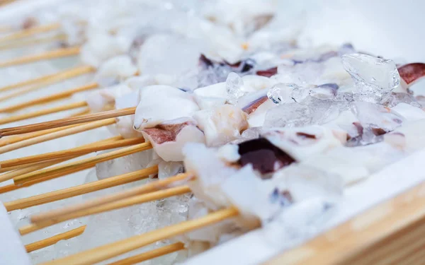 Squids skewers on ice — Stock Photo, Image