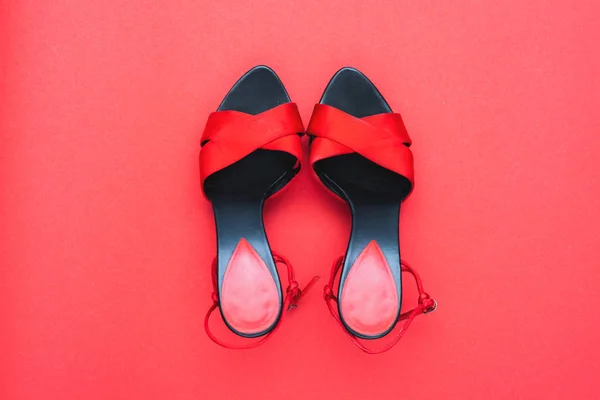 Red female shoes on red background — Stock Photo, Image