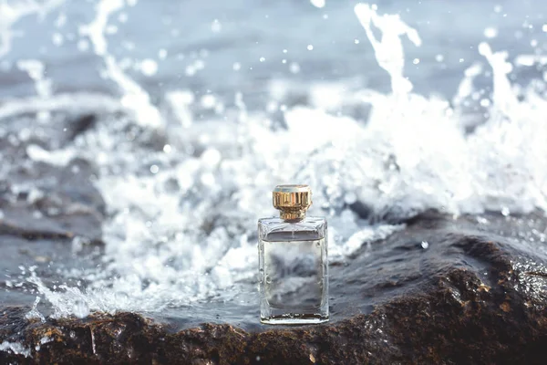 Perfume bottle on a sea wave background