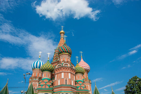 Multicolor towers of St. Basil's Cathedral against a cloudy sky, Moscow, Russia.