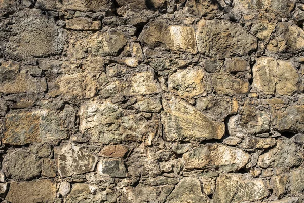 Stone structure of large and small stones in sunlight. — Stock Photo, Image