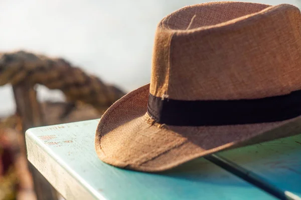 Man straw hat on a blue wooden table