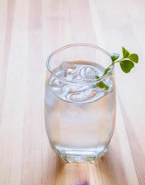 Glass of cold water on wooden table — Stock Photo, Image