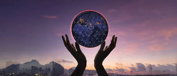 Hands holding earth and circle global network connection with data exchanges worldwide on city sunset background.