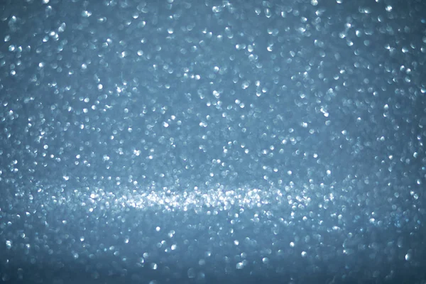 Light sparkles on blue background, snow immitaton — Stock Photo, Image