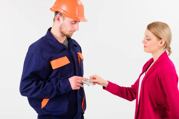 Woman client pay to man in helmet, money in hands — Stock Photo, Image