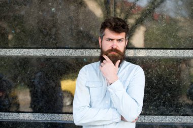 Acımasız adam ciddi yüzle sakalını bir şey hakkında düşünürken çok dokunaklı. Beyaz yakalı adam onun ofis binası, ara iş dışında ayakta