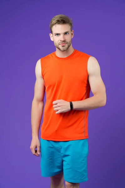Человек Спортивными Умными Часами Фиолетовой Стене Спортсмен Оранжевом Жилете Синих — стоковое фото