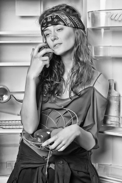Woman with vegetables and fruit at fridge. Sensual woman at open refrigerator. Beauty girl with hippie hair and look. Beauty and look. Food concept. diet and health, black and white.