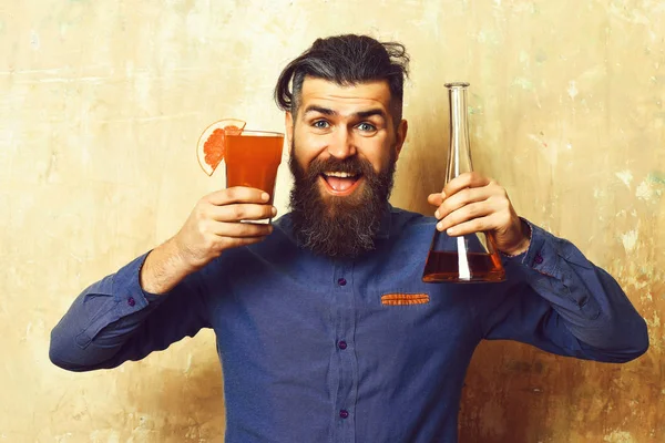 Brutal hipster holding alcoholic shot and glass tube or flask — Stock Photo, Image