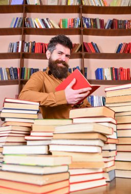 Eğitim ve bilim kavramı. Öğretmen veya kitaplığındaki kitap yığınları arasında sakal eğitim ile öğrenci. Yüz kitap okumak, kitap rafı arka plan üzerinde gülümseyen adamın