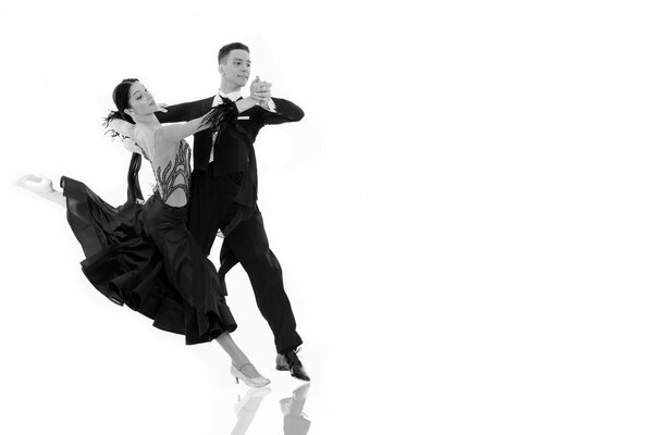 ballroom dance couple in a dance pose isolated on white background. ballroom sensual proffessional dancers dancing walz, tango, slowfox and quickstep black and white