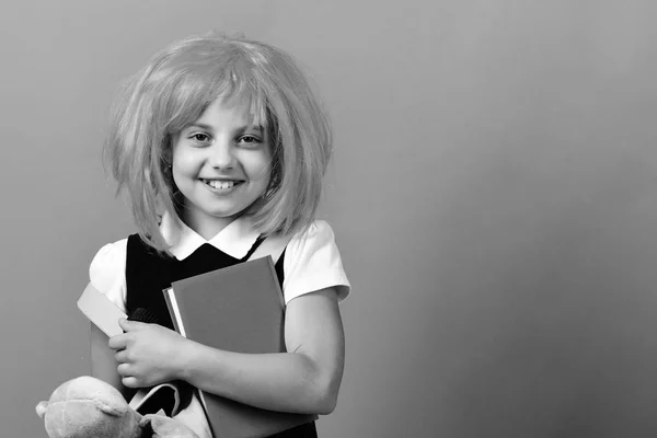 Back to school and education concept. Girl holds blue book — Stock Photo, Image