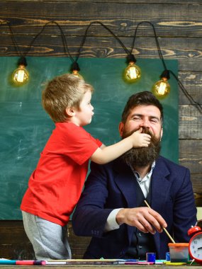 Baba ve çocuk komik surat. Yakışıklı olan oğlu onu iştenuzaklaştırır çalışıyor iken gülüyor