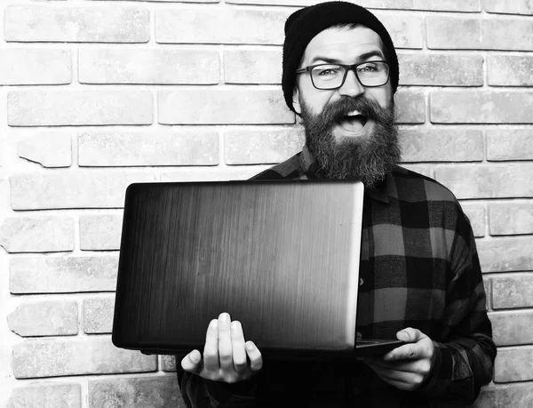 Barbudo brutal caucasiano hipster segurando laptop — Fotografia de Stock