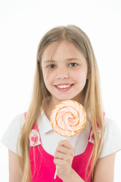 Meisje glimlach met lollipop geïsoleerd op wit. Klein kind lacht met suikergoed op stok. Gelukkig kind met swirl karamel. Voedsel en dessert. Genieten van de zoete lollipop. Voeding en dieet — Stockfoto