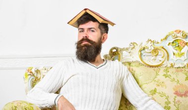 Kavramı çok. Maço kafasına, çatı gibi açık kitap ile oturuyor. Adam, öğretmen öğretim ile overdid, deli profesör oldu. Sakal ve bıyık oturur kanepe, beyaz duvar arka plan üzerinde olan adam