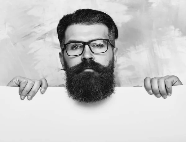 bearded man with serious face in glasses on colorful background