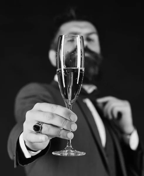 Alcohol addiction loneliness. Man with beard holds glass of champagne.