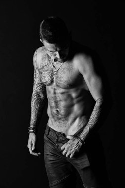 Pazı ve triceps kaslı sporcu. Adam striptiz show seksi gövde. Sporcu altı paketi ve ab sıyırma. Moda adamı dövmesi ile kot. Arzu ve cazibe, siyah ve beyaz