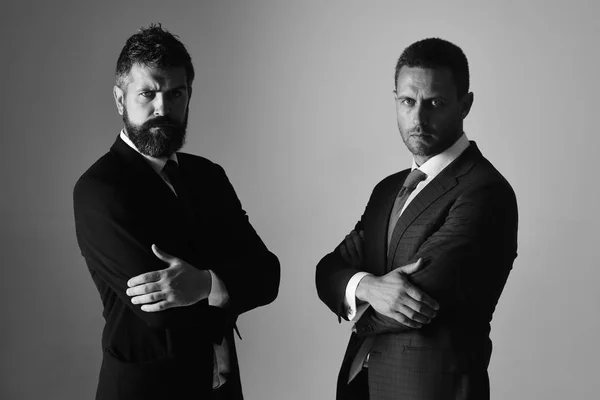 Men with beard and determined faces express confidence and partnership