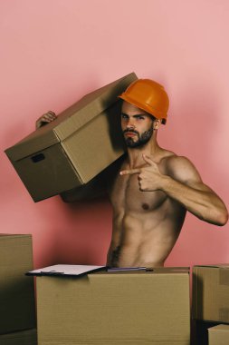 Yükleyici iş başında. Maço selfsatisfied yüzü ile kask takıyor ve klasörü vardır.