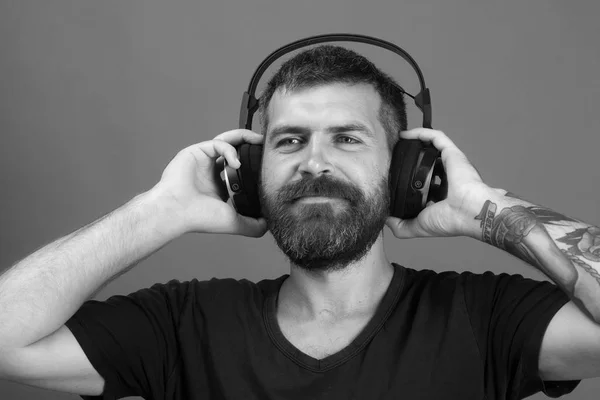 Dj music song. Singer with beard and smiling face enjoys music.
