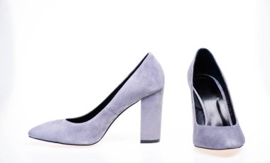 Pair of fashionable high heeled shoes. Shoes made out of grey suede on white background, isolated, copy space. Footwear for women with thick high heels. Fashionable shoes concept clipart