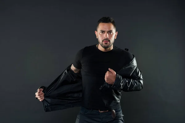 Macho undress leather jacket. Man with beard on unshaven face. Fashion model in casual style clothes. Style and trend. Mens sexuality or attraction and charisma