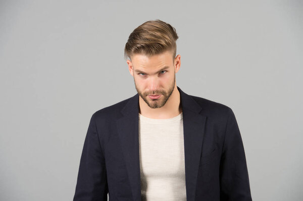 Guy bearded attractive well groomed businessman. Businessman bearded strict calm face manager, grey background. Man with beard unshaven guy looks handsome well groomed formal wear. Fashion concept