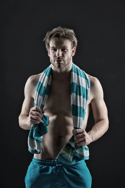 Sexy sportsman with towel on neck after training. Man with muscular chest and belly. Fitness athlete with fit torso in shorts. Sport and wellness. Hygiene or health and bodycare concept, vintage — Stock Photo, Image