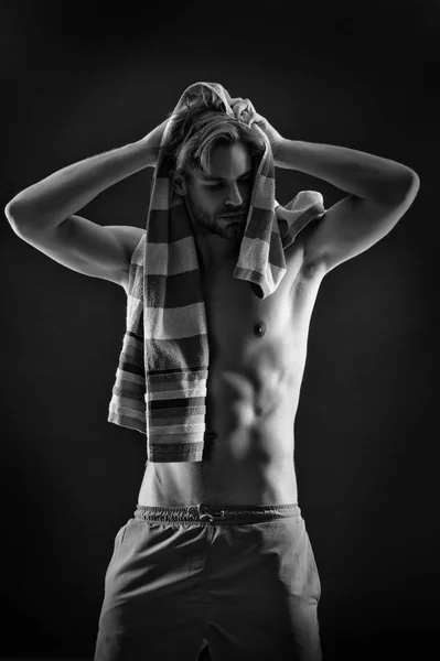 Athlete dry hair with towel after training. Sexy man with fit bare torso. Sportsman with six pack and ab muscles. Sport and fitness. Hygiene or health and bodycare concept, black and white — Stock Photo, Image