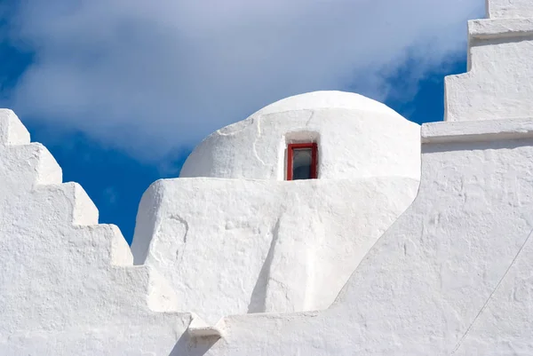 Church dome with small window in Mykonos, Greece. Chapel building architecture detail. White church on cloudy blue sky. Religion and cult concept. Summer vacation on mediterranean island — Stock Photo, Image