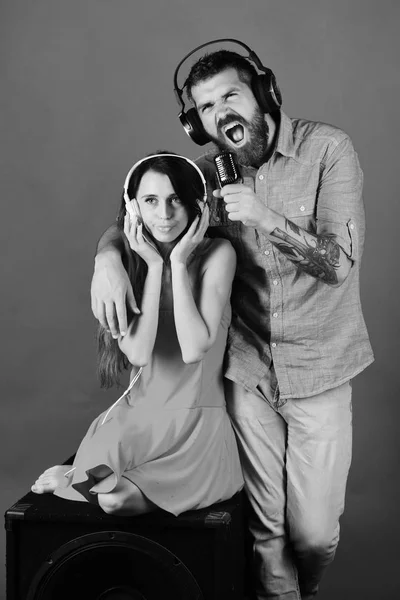 couple listening to music. Party and music concept. Man with beard and girl