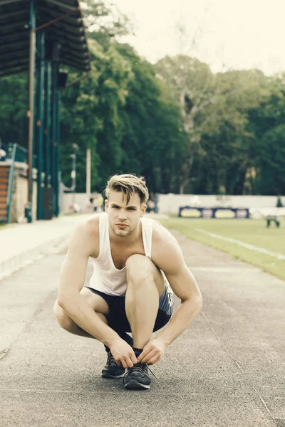 Sportman bindt zijn trainers zitten en klaar om te rennen — Stockfoto