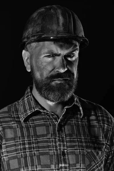 Builder or miner with thick beard. Man with concerned face