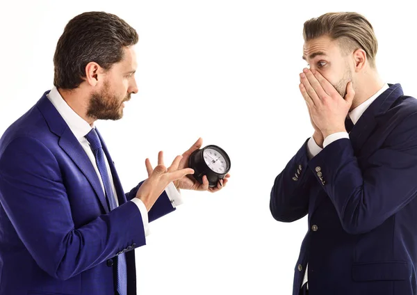Businessman in classic suit holds clock in hand — Stock Photo, Image