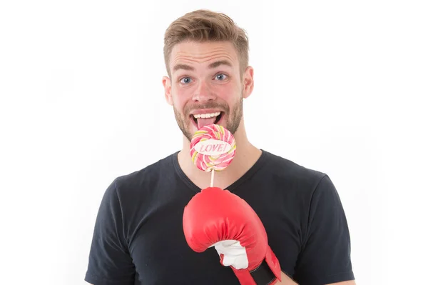 I deserve this. Sportsman boxing glove holds lollipop. Trophy concept. Man athlete cheerful face with sport glove licking sweet candy trophy after victory in fight, isolated white. Boxer happy winner