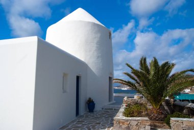Mykonos, Yunanistan deniz yoluyla ev. Badanalı bina ve avuç içi güneşli mavi gökyüzü. Tipik ev mimarisi ve tasarım. Bir Akdeniz Adası yaz tatili. Yolculuk tutkusu ve seyahat kavramı