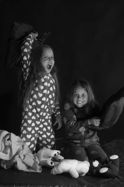 Children have pajama party with pillows. Kids in pajamas have pillow fight, copy space — Stock Photo, Image