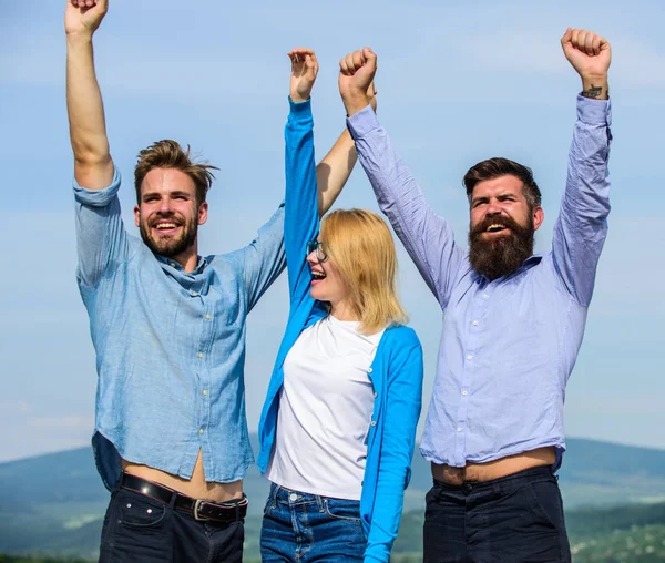 Company three happy colleagues office workers enjoy freedom, sky background. Employees enjoy feeling of freedom. Freedom concept. Men with beard in formal wear and blonde in eyeglasses finished work