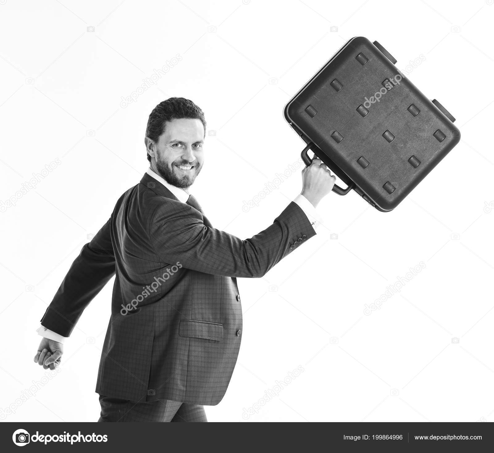 Businessman with smiling face in motion forward man in blue formal suit holds black case and walks business and success concept