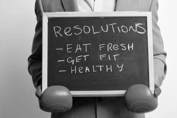 Eat fresh, get fit and health concept. Man in red boxing gloves on white background.